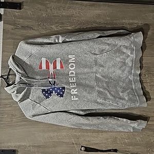 Under Armour men's medium loose fit heather gray hoodie with the word "Freedom"
